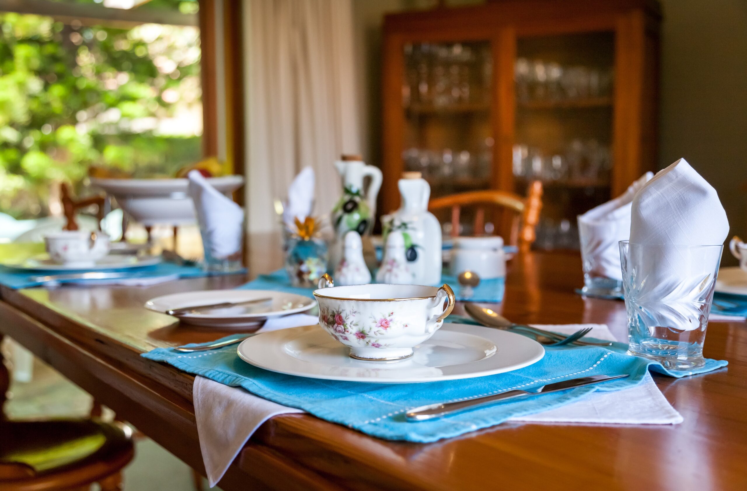 a dining room with a set of fine china on the table