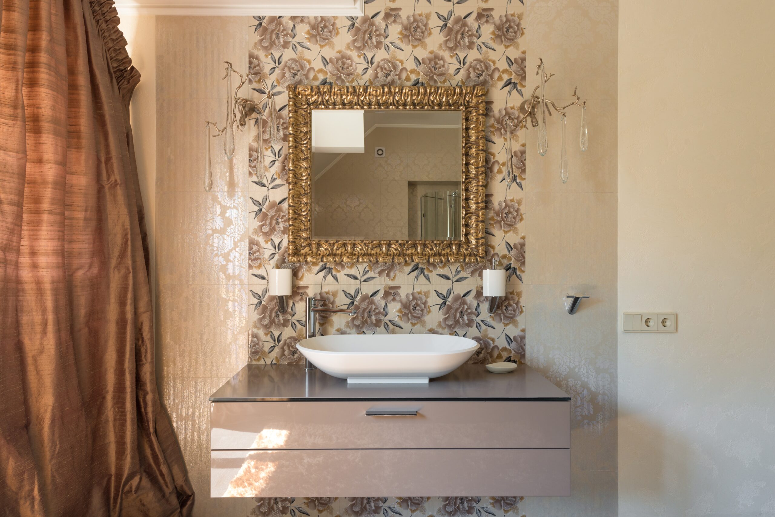 a bathroom with a gold mirror