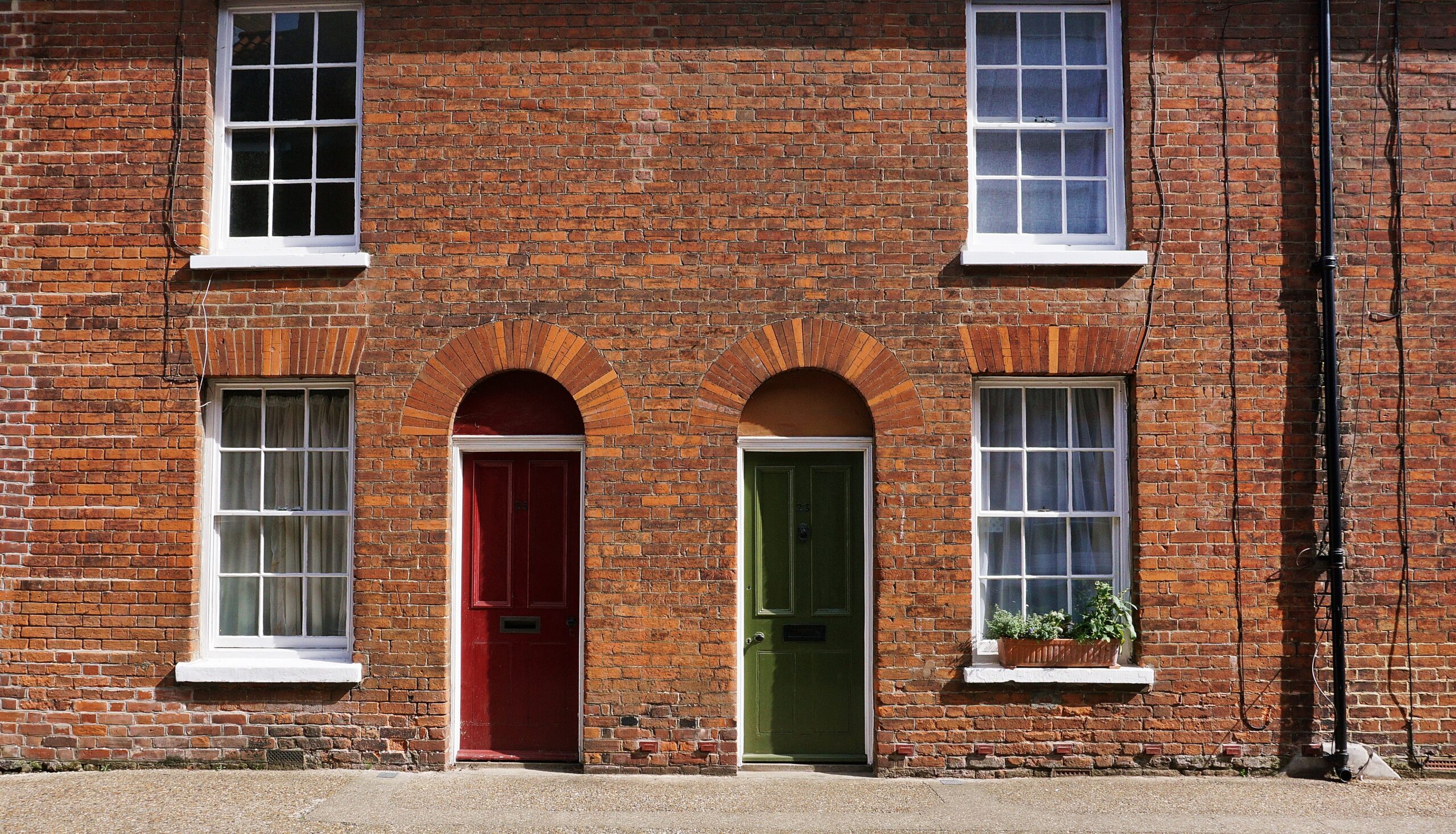 Building with brick walls and colorful doors.