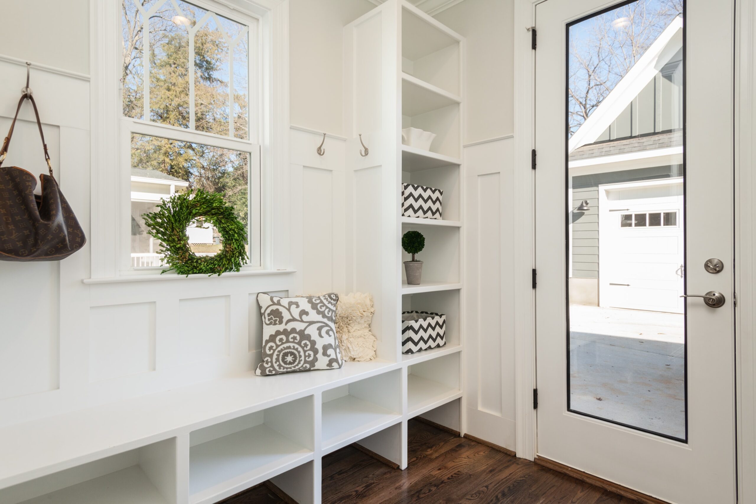 A white hallway with storage shelves.